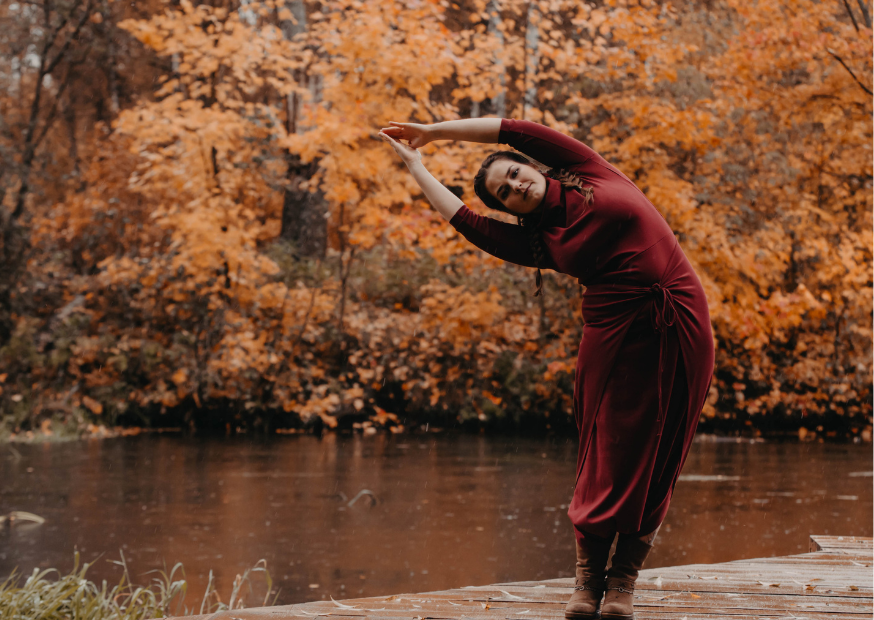 woman practising yoga by a river